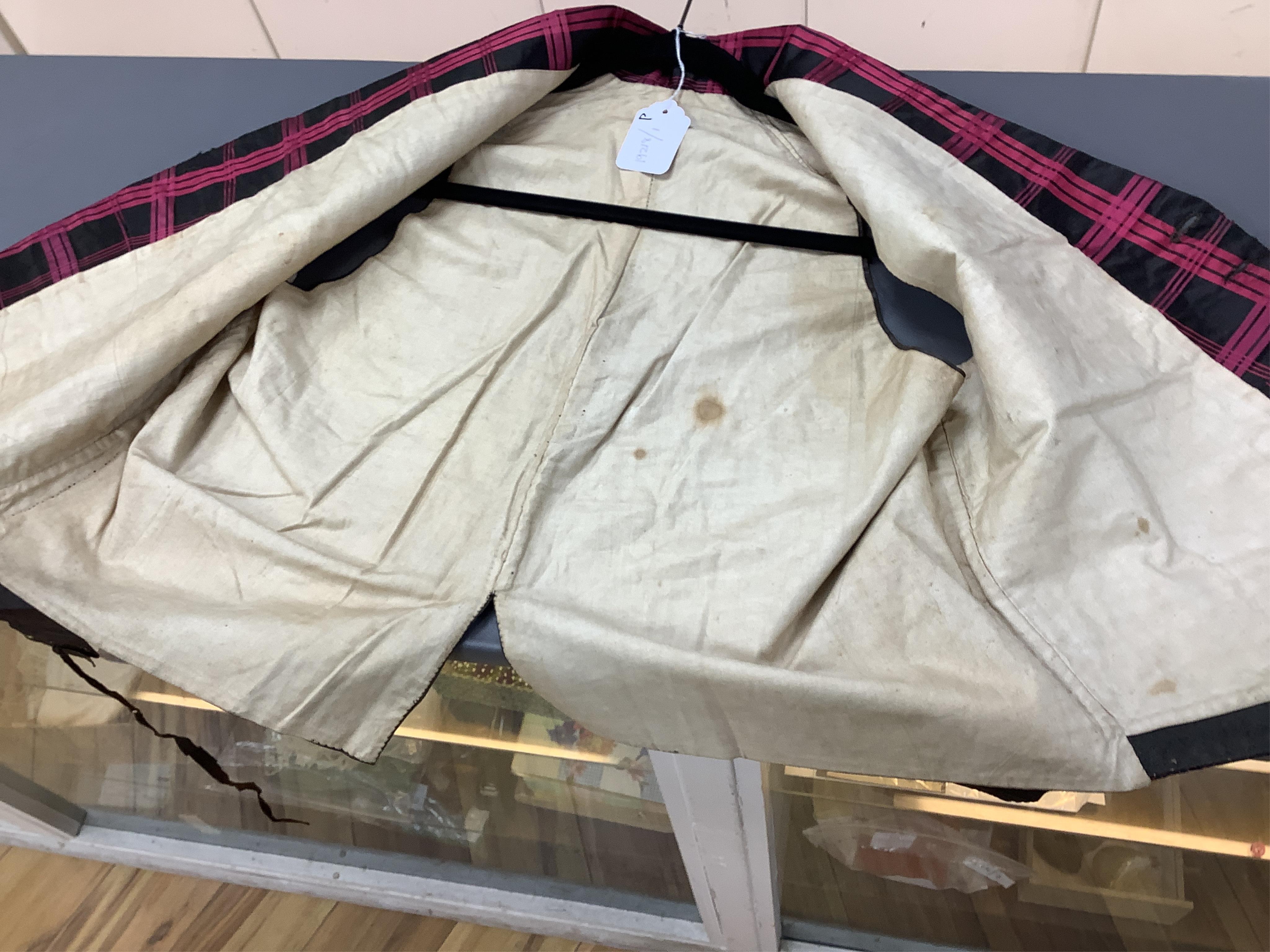 A 19th century gentleman's pink and black silk check waistcoat, with collar and two pockets. Front under arm chest 50cm. Condition - lining stained may need professional cleaning.